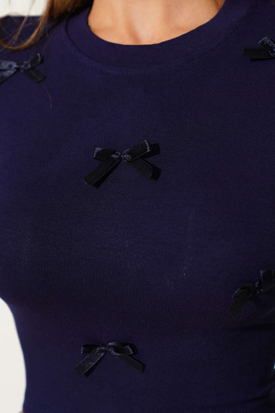 Long-sleeved crop top with bow detail, navy blue.