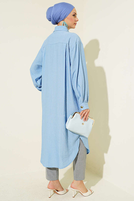 Chemise longue bleue avec poches et boutons cachés