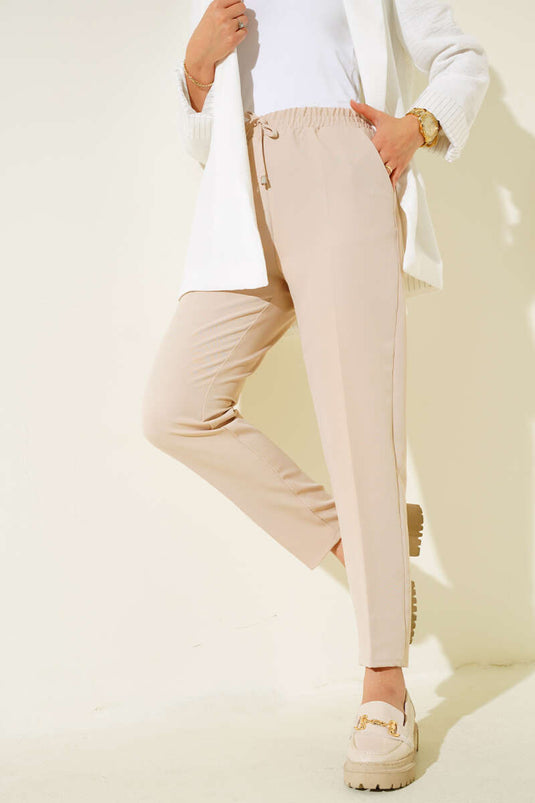 Pantalon skinny beige à taille élastique avec détails en corde