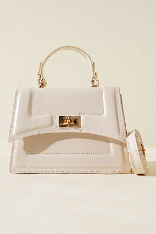 Cream-colored bag with lock detail and edge stitching.