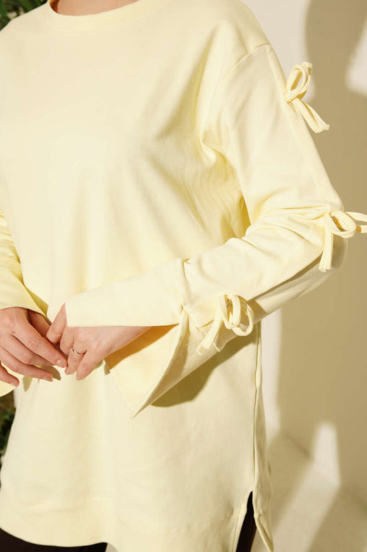 تونيك أصفر بتفاصيل فيونكة على الأكمام