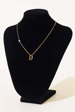 Collier lettre perlé mauvais œil D