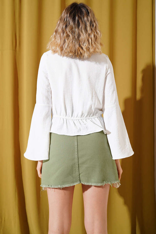 Chemisier écru à col V et nœud sur le devant