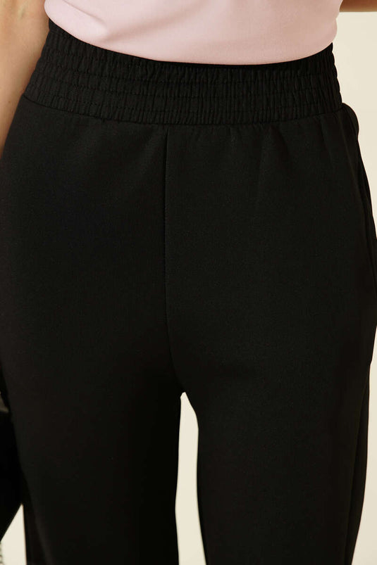 Pantalon en scuba noir avec poches à pince et taille élastiquée
