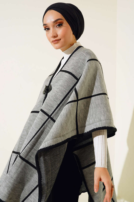 Poncho con detalle de borlas Gris