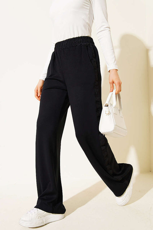 Pantaloni con elastico in vita e dettaglio a strisce neri