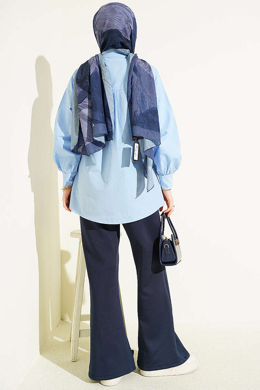 Blue Shirt with Hidden Buttons and Jeweled Brooch