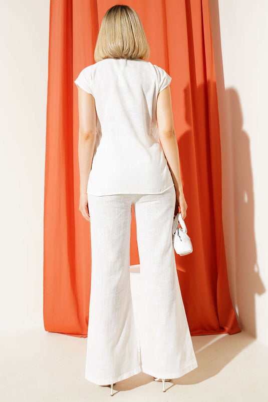 Ensemble deux pièces en lin blanc à col en V et liens sur le côté