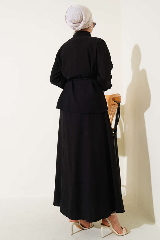 Two-piece set with skirt and collar ruffle detail, black.