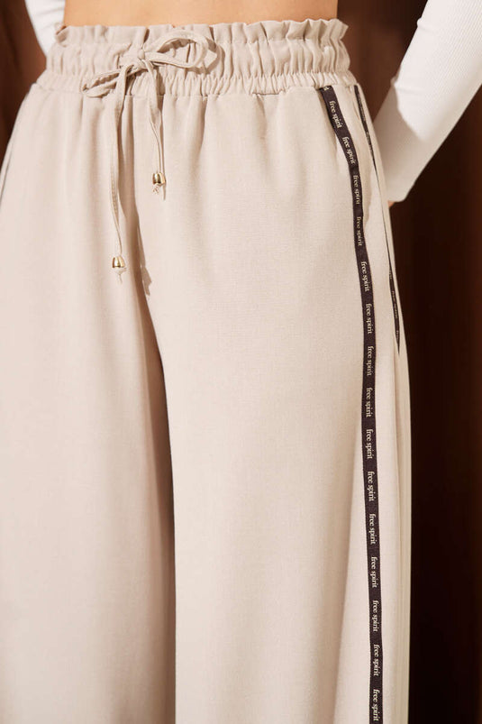Pantalon Palazzo beige à taille élastique avec bande latérale contrastante