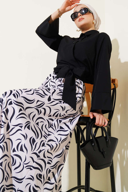 Traje negro de dos piezas con falda y lazo lateral