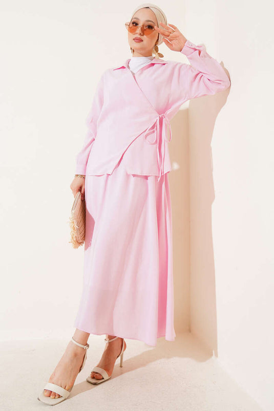 طقم من قطعتين مع تنورة برباط جانبي، وردي