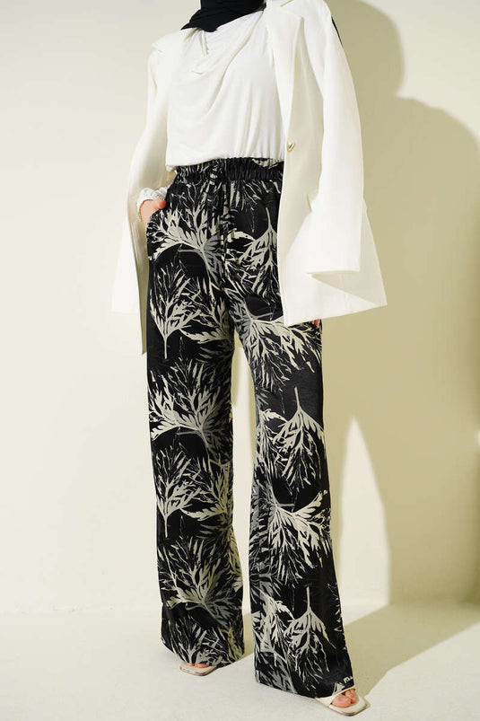 Pantalon large en satin à motif feuille noir