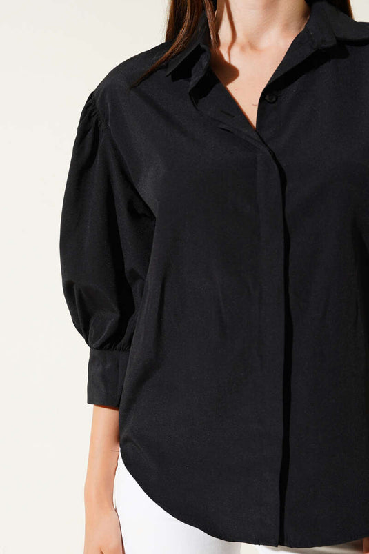 Chemise noire à manches demi-ballon