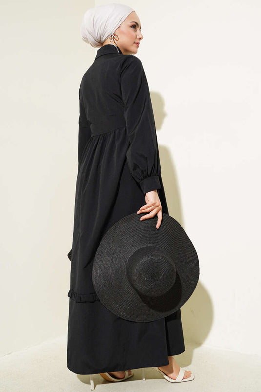 Robe noire à volants et demi-boutonnage avec lien sur le côté